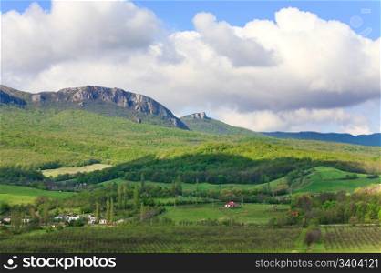 spring mountain landscape and village in foreground (environs of Sokolinoe village , Crimea, Ukraine)