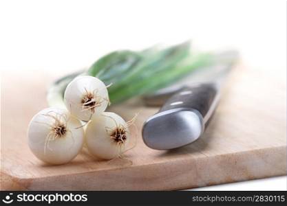 Spring onions. Three bulbs spring onions on white background