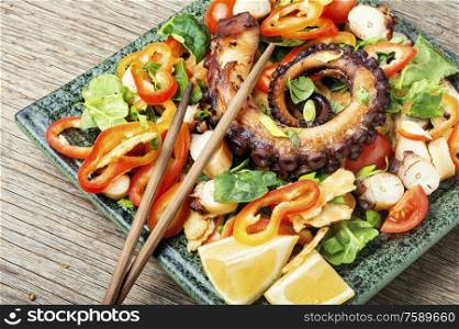 Spring or summer salad with vegetables and octopus.Seafood salad. Vegetable salad with octopus.