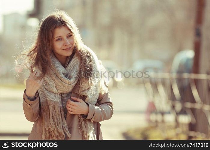 spring photo beautiful girl in a coat in the city
