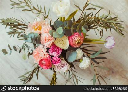 Spring pink bouquet with tulips and eucalyptus in a vase. Spring pink bouquet