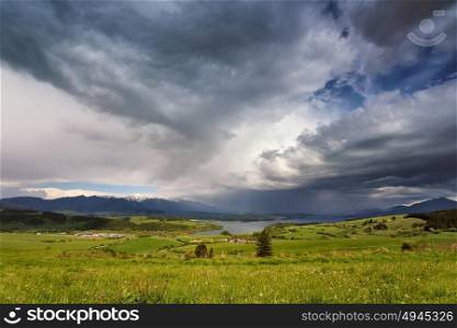 Spring rain and storm in mountains. Green spring hills of Slovakia. Spring stormy scene