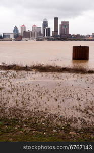 Spring rains flood the Ohio River banks along the shore of the largest city in Kentucky