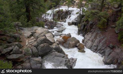 Spring river washing down hill in Yosemite