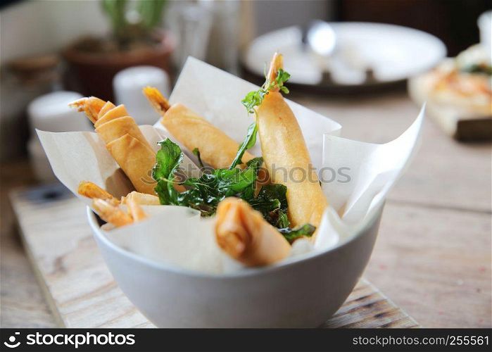 Spring rolls with shrimp with sweet chili sauce. Asian food on wood background