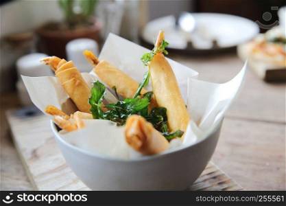 Spring rolls with shrimp with sweet chili sauce. Asian food on wood background