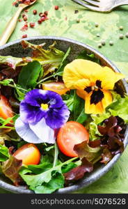 Spring salad with herb and flower. Vegetarian dietary salad with arugula, salad and flowers