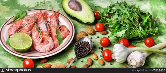spring salad with large shrimp,avocado,tomato and greens. banner with large prawns and seasonal vegetables