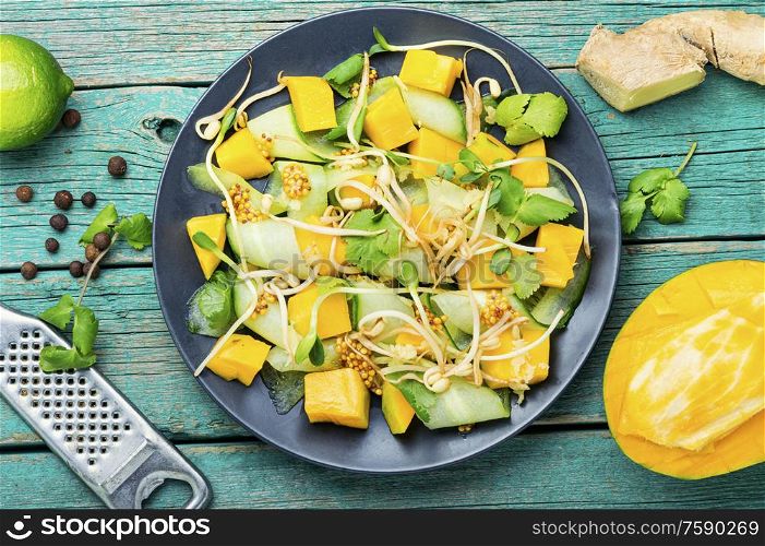 Spring salad with mango, cucumber and sprouts.Vegetable salad of sprouted mung beans. Salad with mango and vegetables.