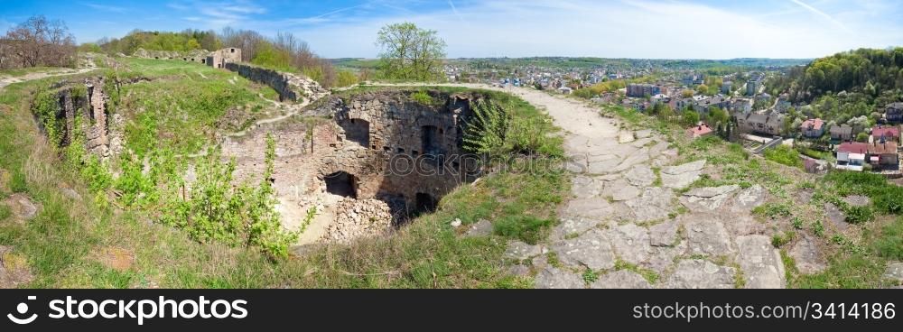 Spring view of Terebovlia castle ruins and Terebovlya town on the right (Ternopil Oblast, Ukraine). Built in 1366. Four shots stitch image.