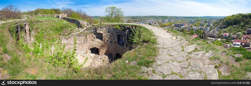 Spring view of Terebovlia castle ruins and Terebovlya town on the right (Ternopil Oblast, Ukraine). Built in 1366. Four shots stitch image.