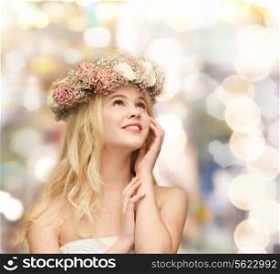 spring, wedding and people concept - young woman wearing wreath of flowers