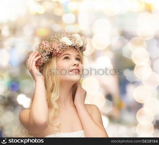 spring, wedding and people concept - young woman wearing wreath of flowers