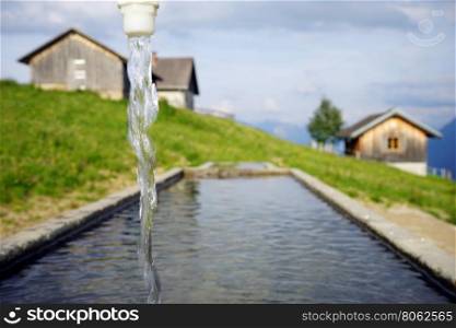 Spring with clean water near farm houses in Lichtenstein