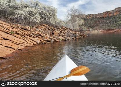 springtime canoe paddling - canoe bow with a paddle on Horsetooth Reservoir near Fort Collins, Colorado in spring scenery