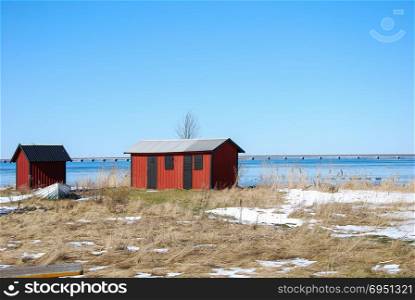 Springtime with red cabins by the coast of the swedish island Oland in the Baltic Sea