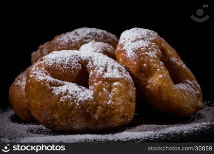 Sprinkling sugar powder on delicious homemade donut