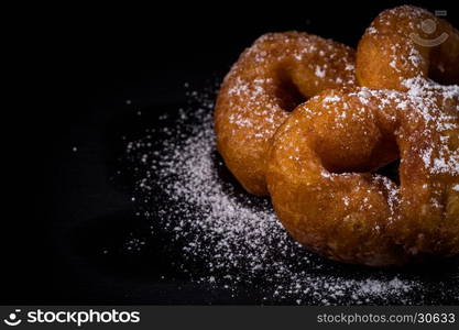 Sprinkling sugar powder on delicious homemade donut