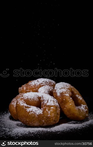 Sprinkling sugar powder on delicious homemade donut