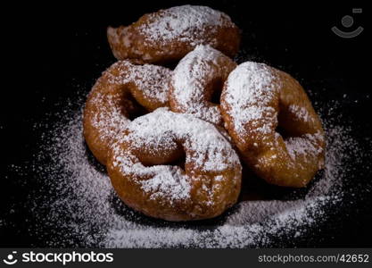 Sprinkling sugar powder on delicious homemade donut