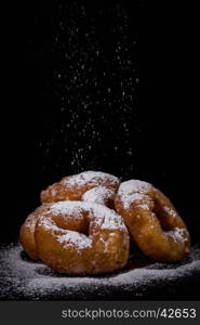 Sprinkling sugar powder on delicious homemade donut