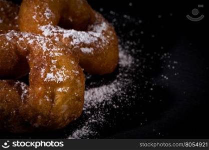 Sprinkling sugar powder on delicious homemade donut