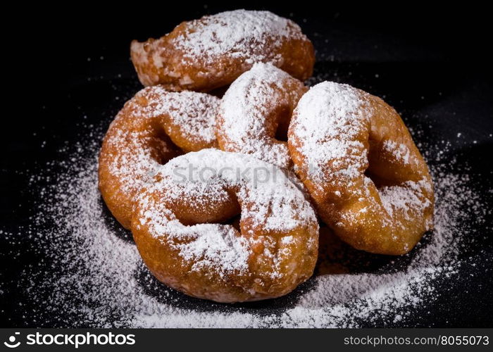 Sprinkling sugar powder on delicious homemade donut