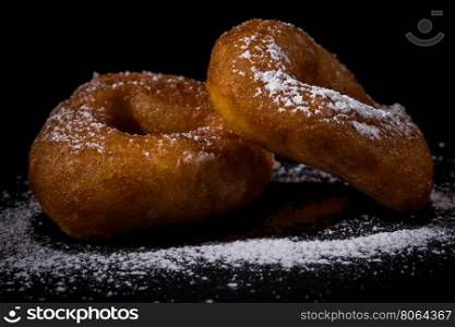 Sprinkling sugar powder on delicious homemade donut