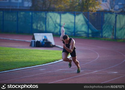 Sprinter leaving starting blocks on the running track. Explosive start.