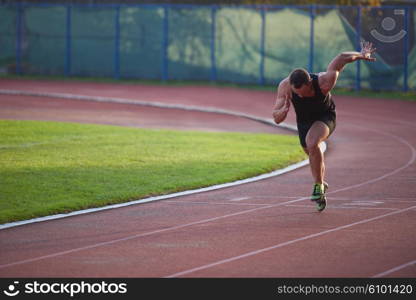 Sprinter leaving starting blocks on the running track. Explosive start.