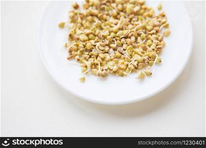 sprouted buckwheat grains on a plate, healthy food, fitness, sports, diet.. sprouted buckwheat grains on a plate, healthy food, fitness, sports, diet