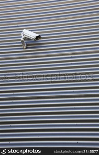 spy camera on corrugated iron building