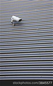 spy camera on corrugated iron building