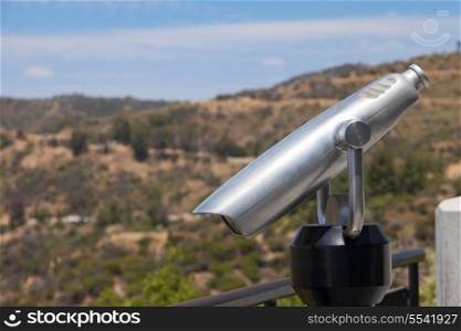 Spyglass and nature landscape with the hills and blue sky&#xA;