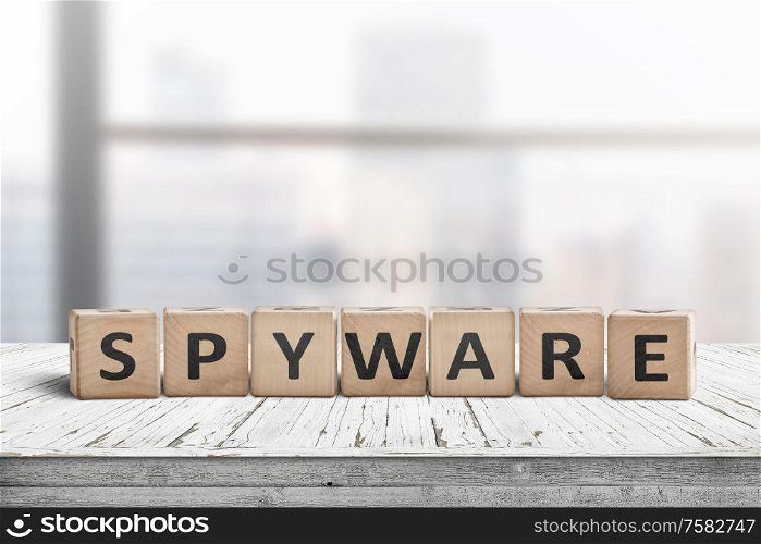 Spyware word on wooden cubes in a bright office on a white painted desk