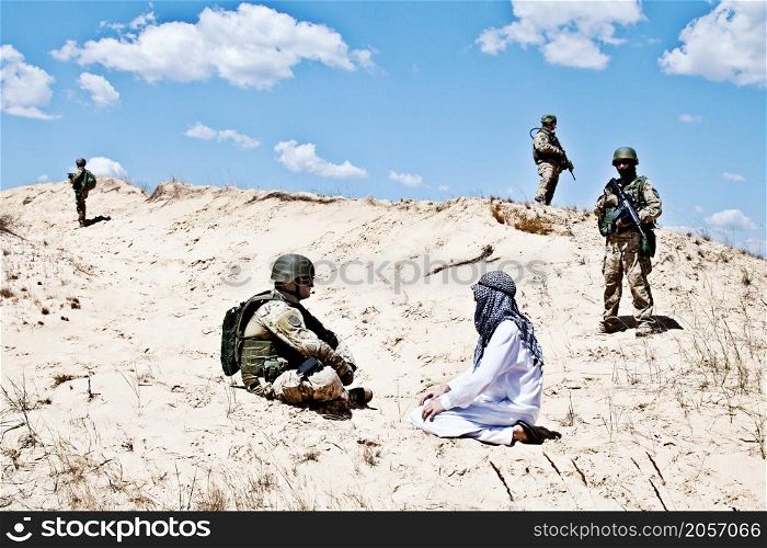 Squad of soldiers guarding the perimeter while negotiations with muslim warrior are going on