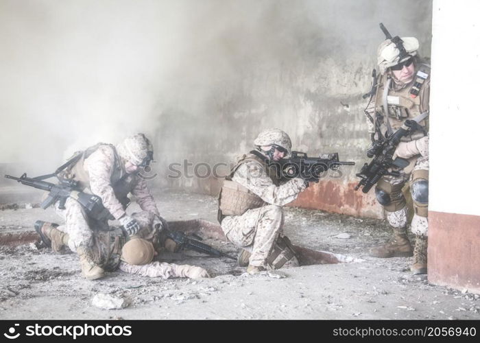 Squad of US marines in action in ruined building