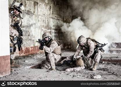 Squad of US marines in action in ruined building