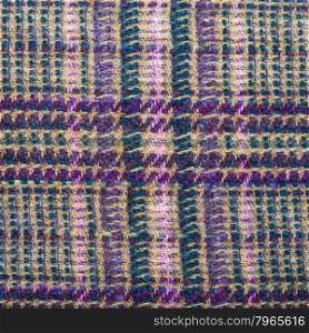 square background from checkered green, brown, violet, pink woolen fabric close up