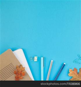 Square Creative flat lay top view back to school concept with color school and office supplies on bright turquoise paper table frame background with copy space, template for text or design