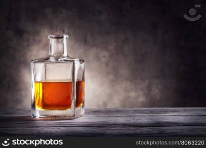 Square decanter of brandy on a dark background. Square decanter of brandy