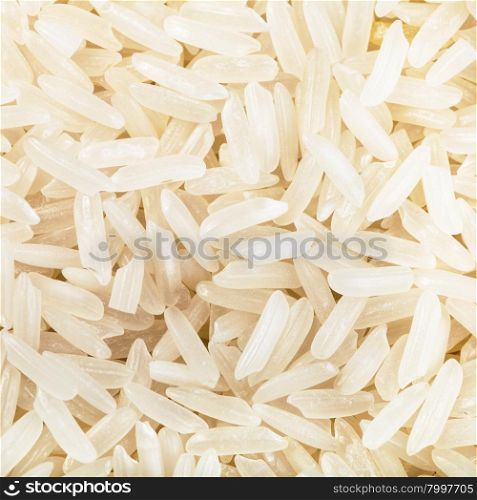 square food background - long-grain uncooked white jasmine rice