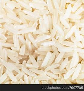 square food background - long-grain uncooked white jasmine rice