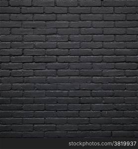 square part of black painted brick wall