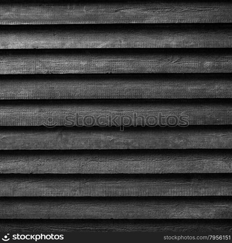 square part of black wooden fence or part of black painted barn in black and white