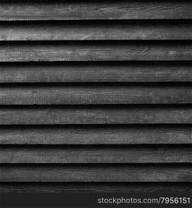 square part of black wooden fence or part of black painted barn in black and white