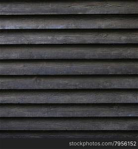 square part of black wooden fence or part of black painted barn