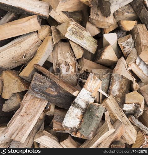 square picture of pile of firewood ready to burn