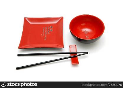 Square red plate, round bowl and chopsticks on stand