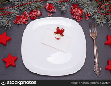 square white empty plate and iron fokr on a black background